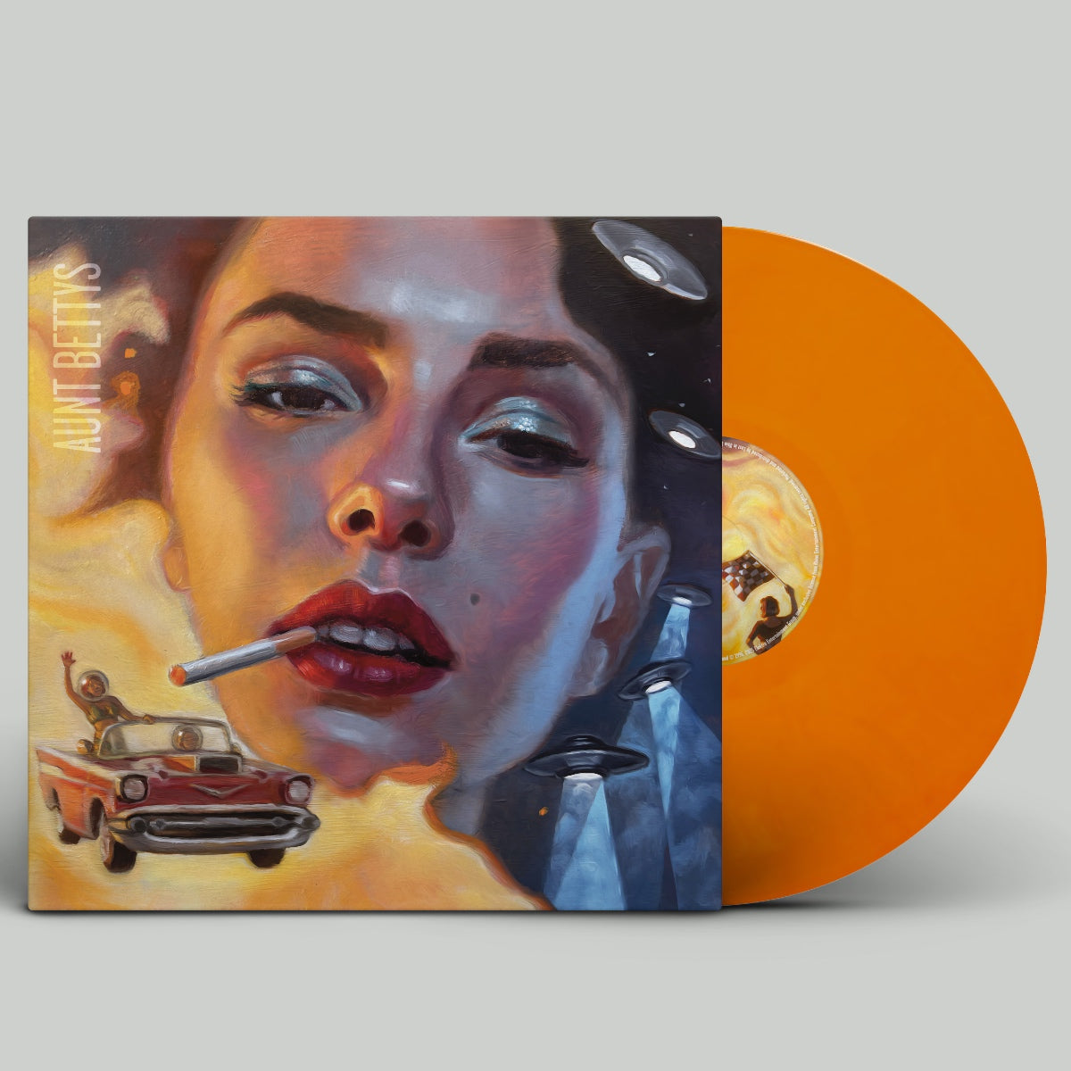 Vinyl record with a colorful cover featuring a woman's face, a car, and abstract elements on an orange background.