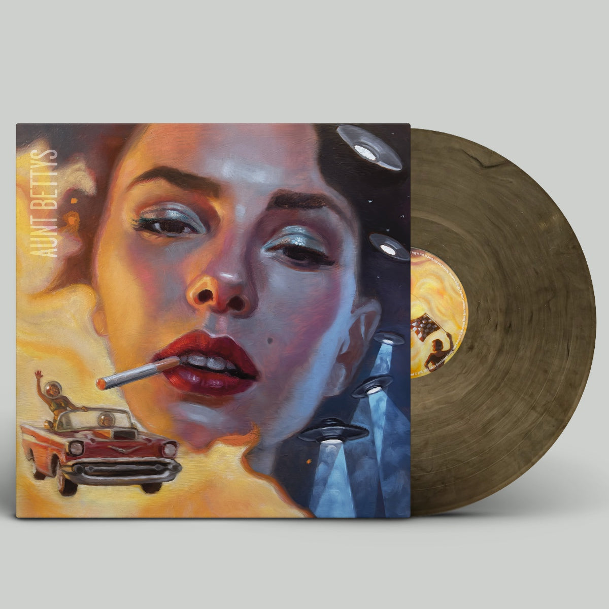Vinyl record with a colorful cover featuring a stylized face and car, on a light gray background.